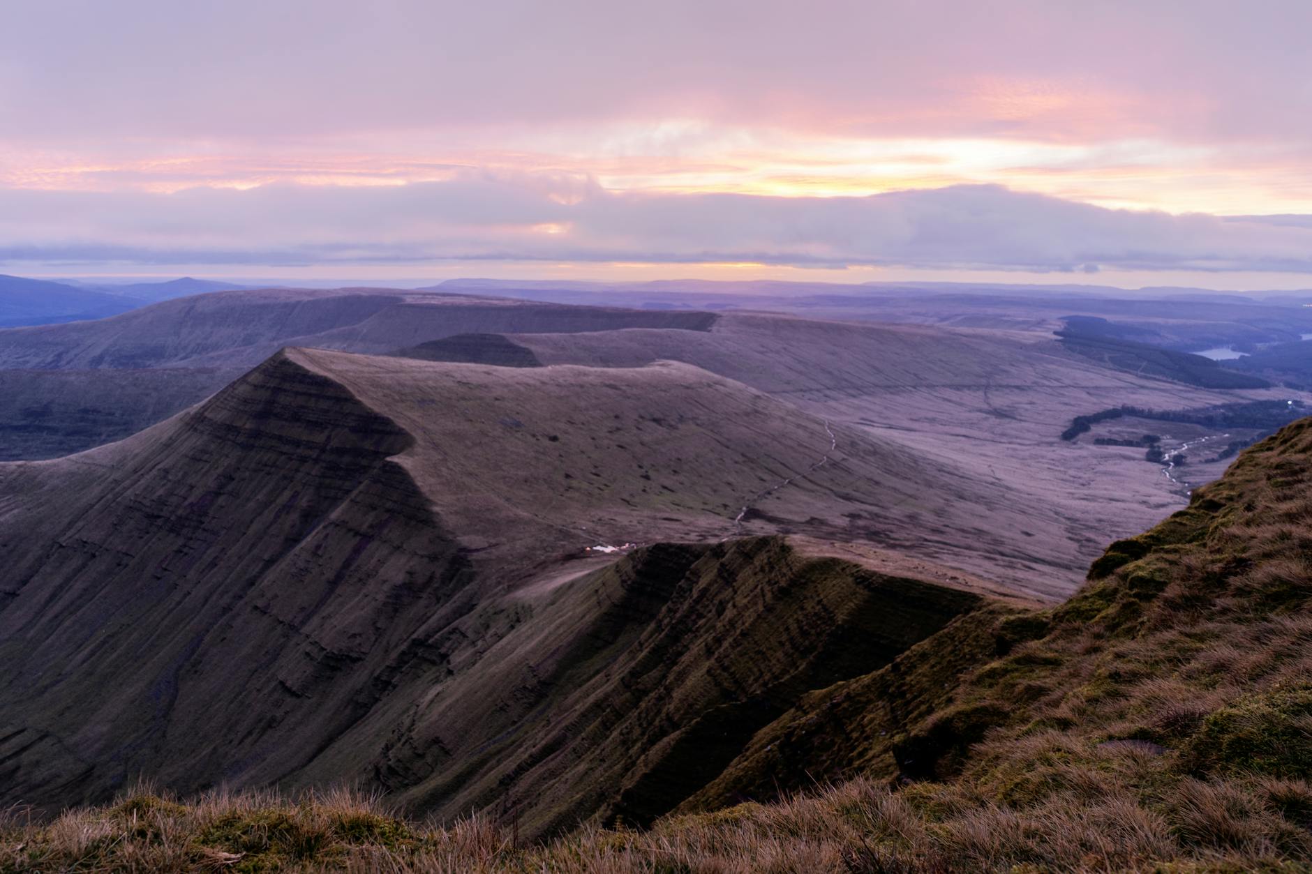 scenic landscape with a mountain range at sunset